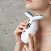Handheld electronic device held by a person against a neutral background
